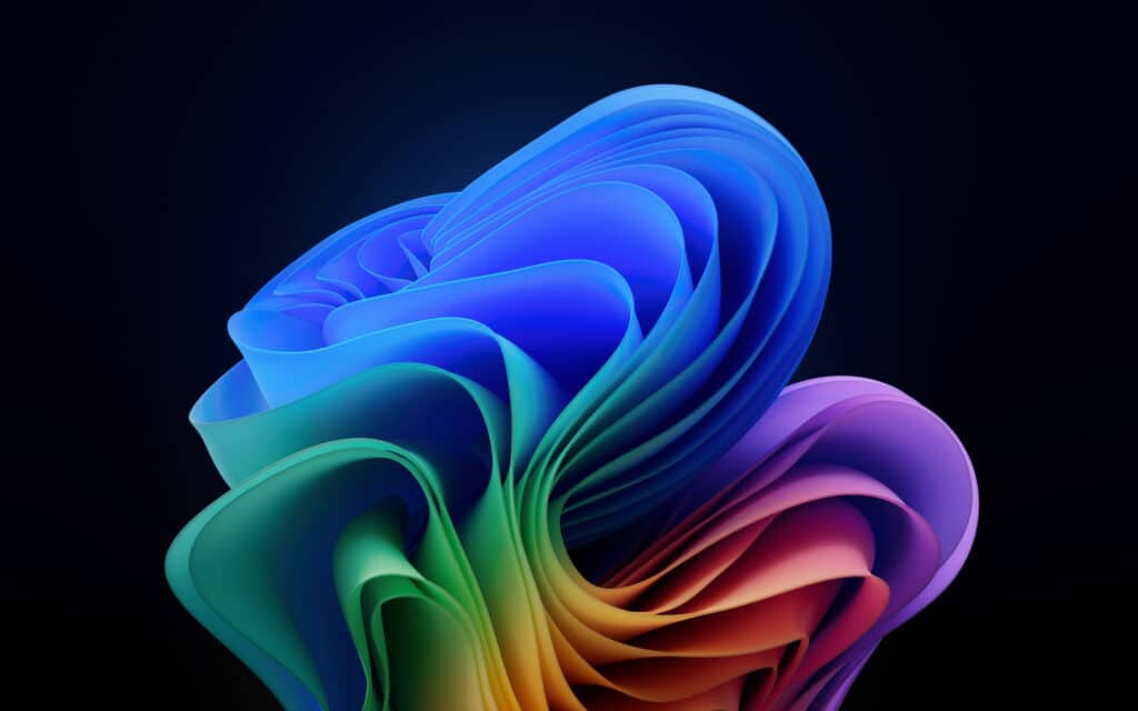 Windows 11 Bloom wallpaper with vibrant 3D abstract design on a dark background.